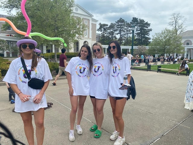 Four Union College students posing in front of the library during Pride Fest 2022.