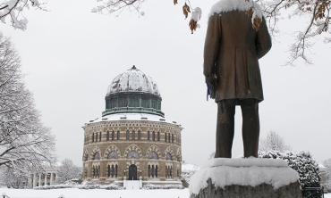  A snowy day view of the Nott Memorial, with the back of the Chester Arthur statue visible in the foreground.
