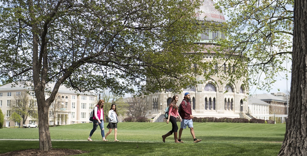 Students walking across campus with the Nott Memorial visible in the background.
