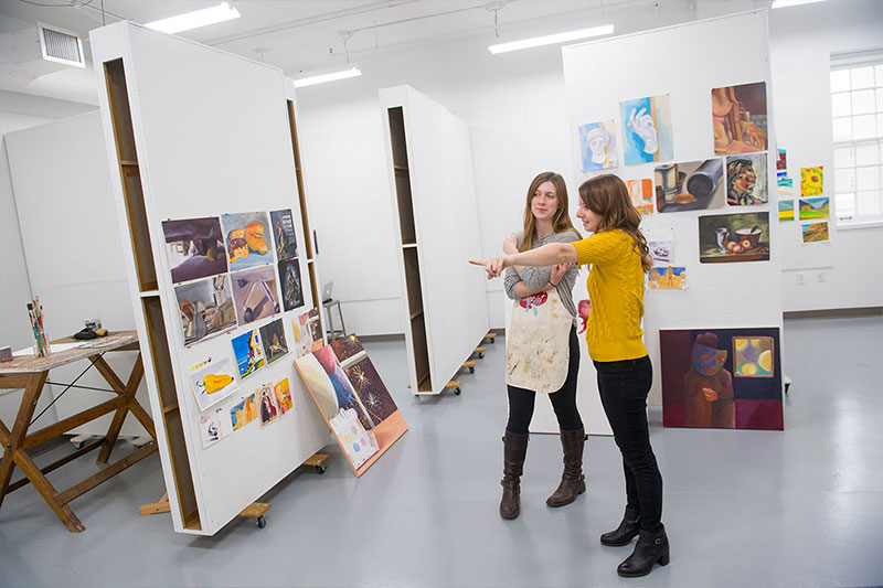 Laini Nemet, visual arts professor, with a student in the painting studio