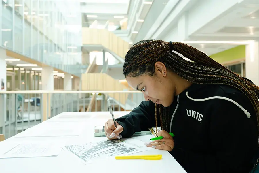 Danielle Brown works on her project at a table in ISEC