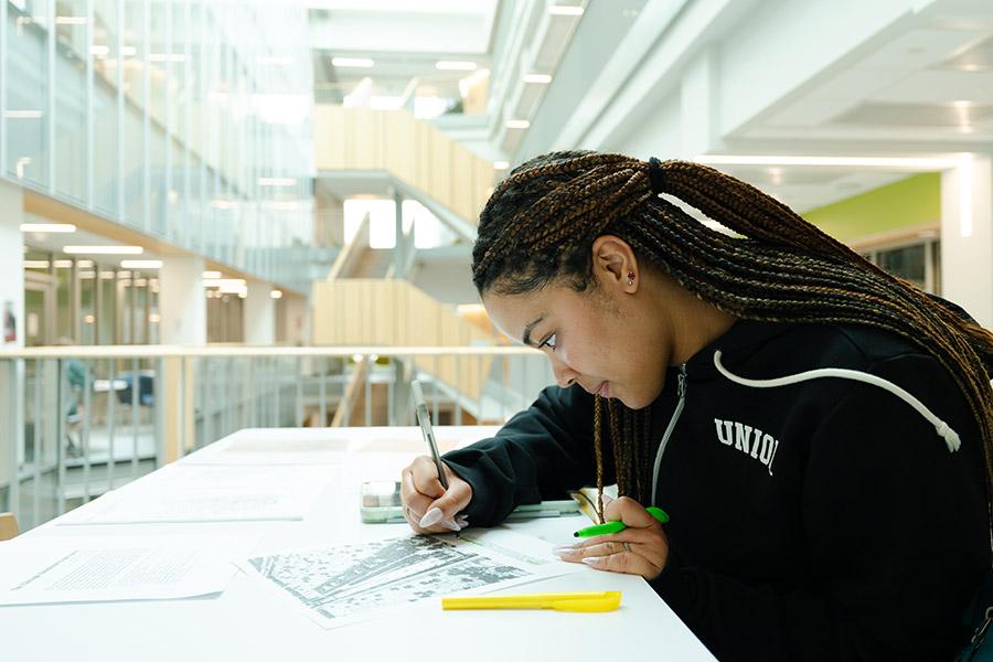Danielle Brown works on her project at a table in ISEC
