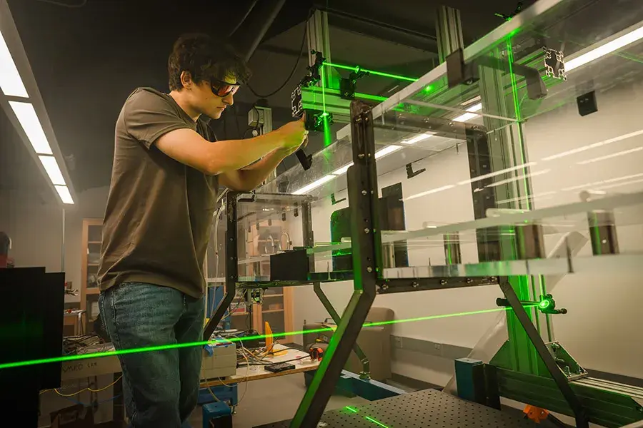 Eduardo Castro works with lasers in a lab