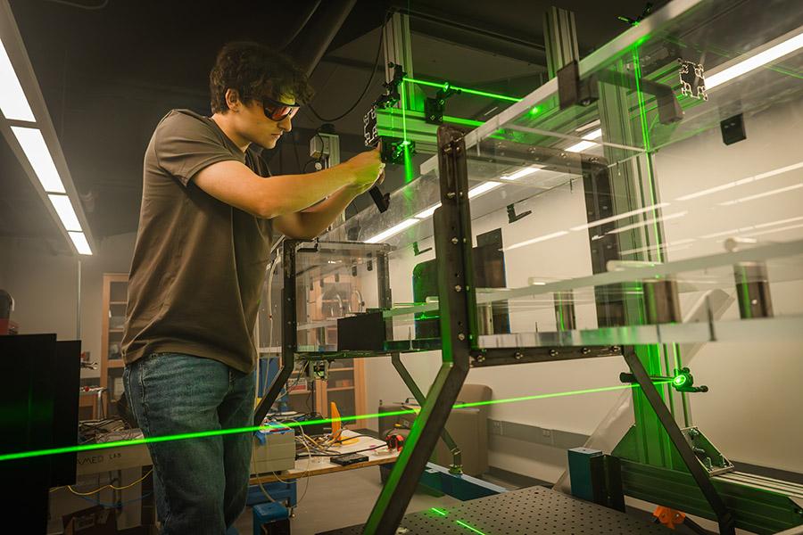Eduardo Castro works with lasers in a lab