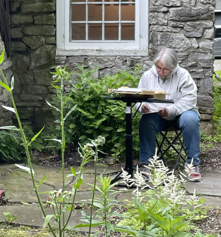 Faculty member writing at Kelly Adirondack Center
