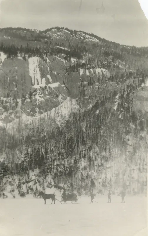 photo of a frozen lake with a snowy mountain behind