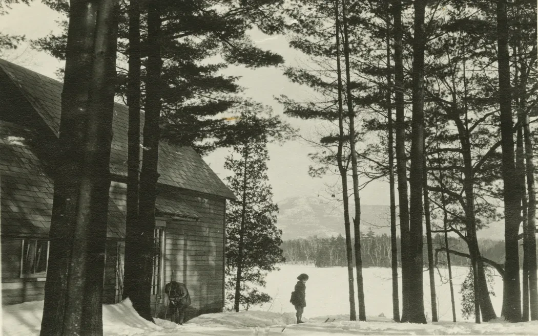 photo of a little girl next to a camp on a lake