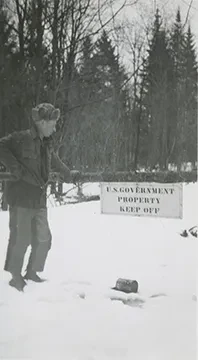 photo of a man by a state land sign