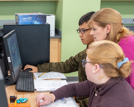 Faculty working with students