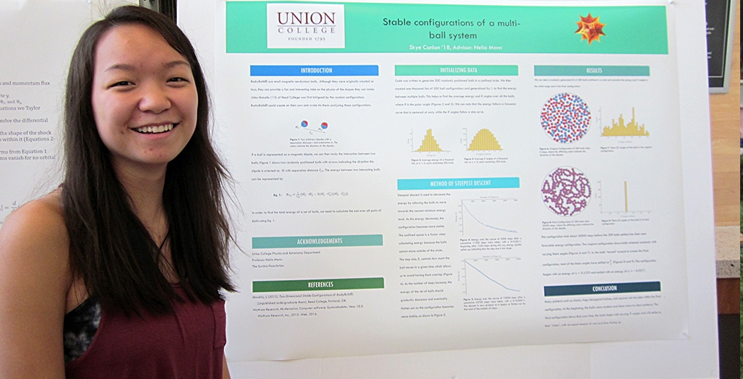 Student Skye Colnlan '18 with poster of  Stable configuration of a multi-ball system.