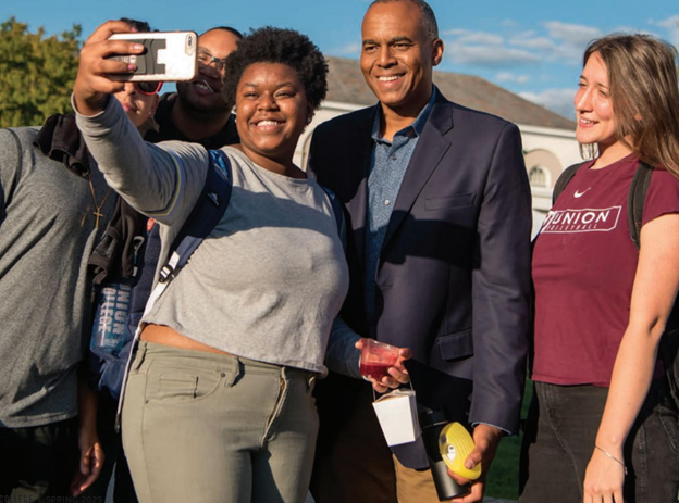 President Harris with multiple students taking a selfie