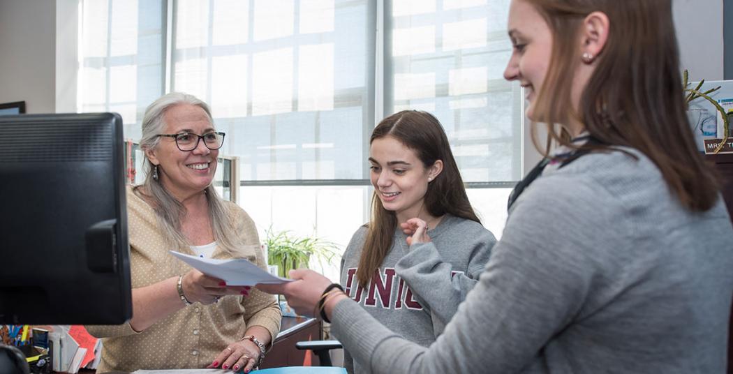 Trish VanDerhoof, in the Dean of Students Office assists some Union students.