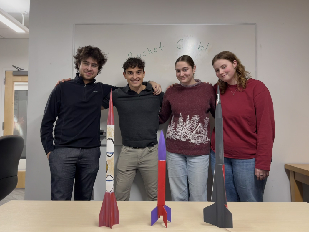 Rocket team members with model rockets