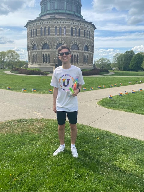 Dan Wilcox, Class of 2022, President of Union Pride and Pride Fest Organizer, stands in front of the Nott Memorial,