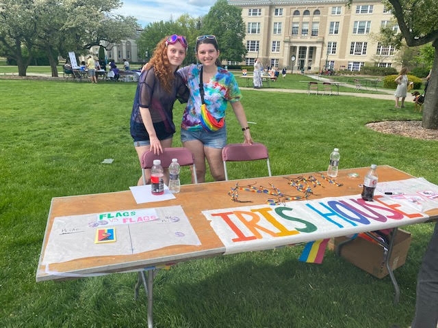 Members of Iris House stand at the Iris House table during Pride Fest 2022.