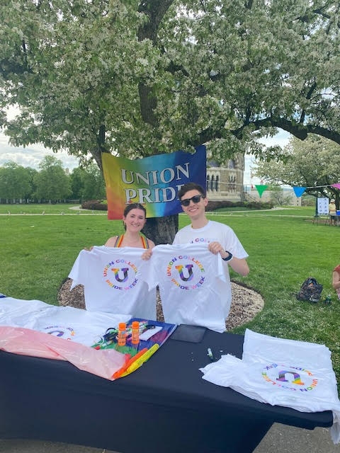 Two Union College students holding up Pride Fest t-shirts during Pride Fest 2022.
