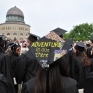 Graduation photo of students outside with Nott Memorial in background