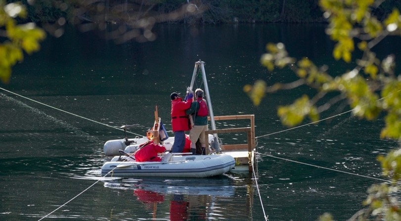 Photo shows two people on a boat in Crawford Lake, Canada