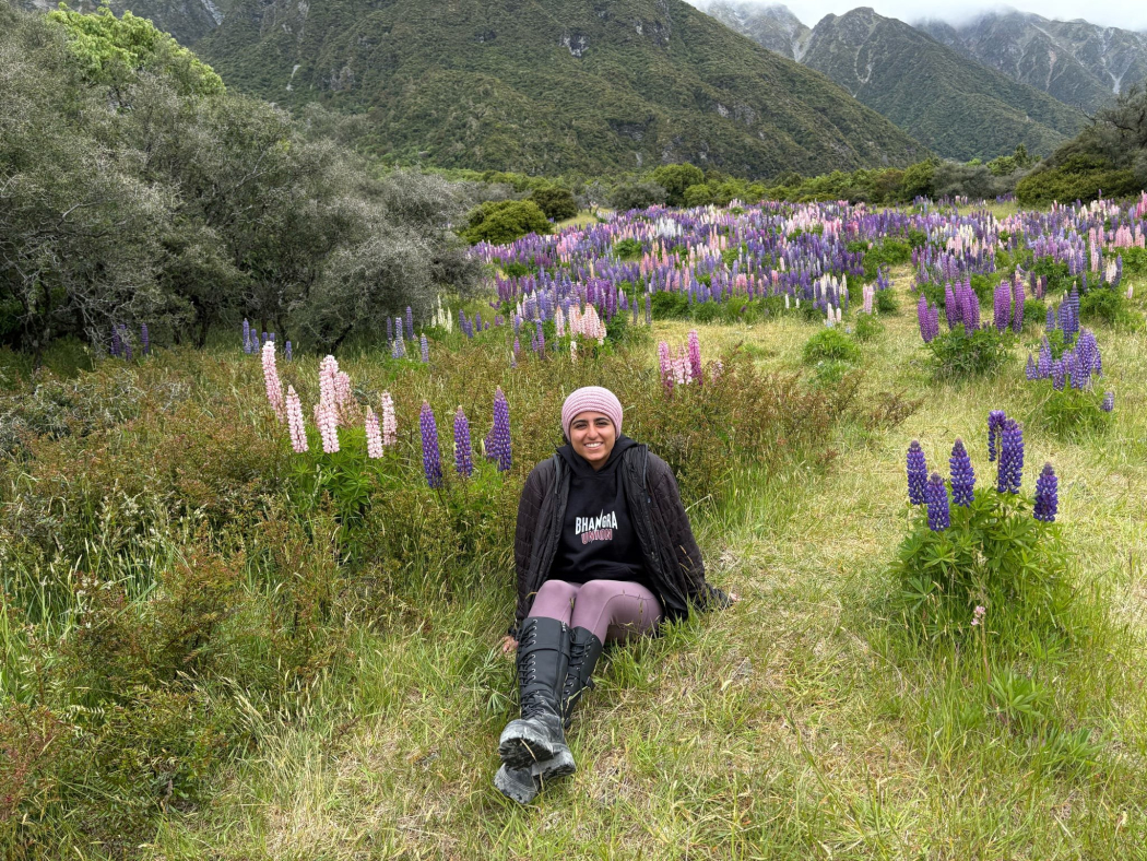“Pictured is Ria appreciating seasonal lupin flowers during a hike in Aoraki/Mount Cook on New Zealand's South Island”