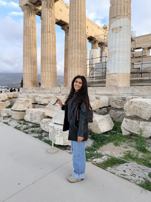 Priya pictured on the Acropolis of Athens in front of the famous Parthenon.