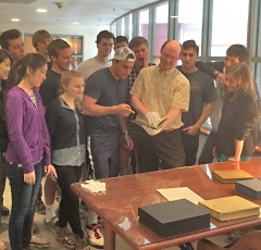 Professor Wilkin holding the first edition of Galileo’s 1610 book announcing the discovery of 4 moons around Jupiter. The students are from the Sophomore Research Seminar “New Worlds”.