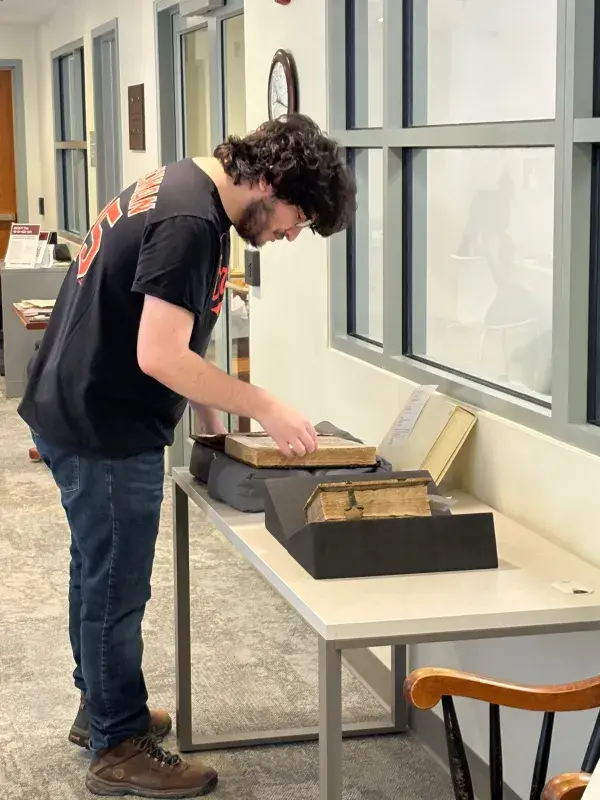 A student researching using a rare book in Special Collections & Archives