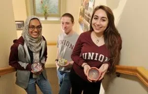 Empty Bowls student organizers Sharmeen Azher '17, Ian Koon '18 and Hannah Ellen '19 hold bowls that will be available at this weekend's event. (Paul Buckowski/Times Union photo)