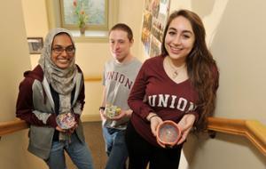 Empty Bowls student organizers Sharmeen Azher '17, Ian Koon '18 and Hannah Ellen '19 hold bowls that will be available at this weekend's event. (Paul Buckowski/Times Union photo)