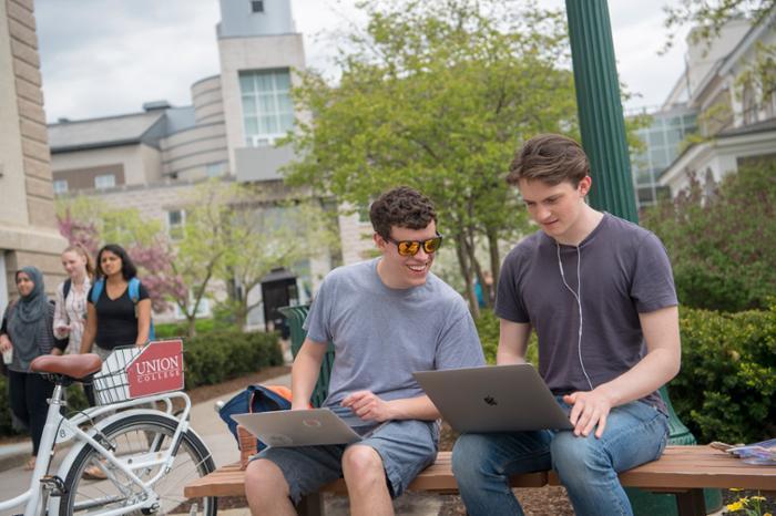 Students looking at their laptops.