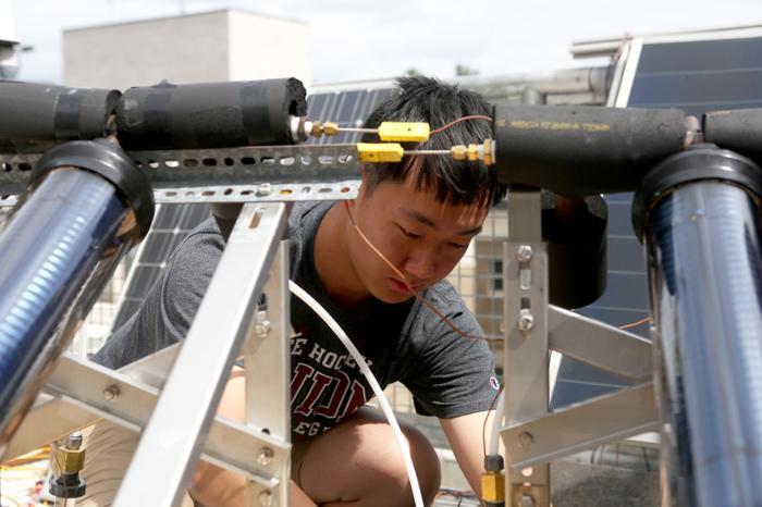 Sunan Sun ‘20 works on the roof of Wold Center as part of his research learning about the applications of solar energy.