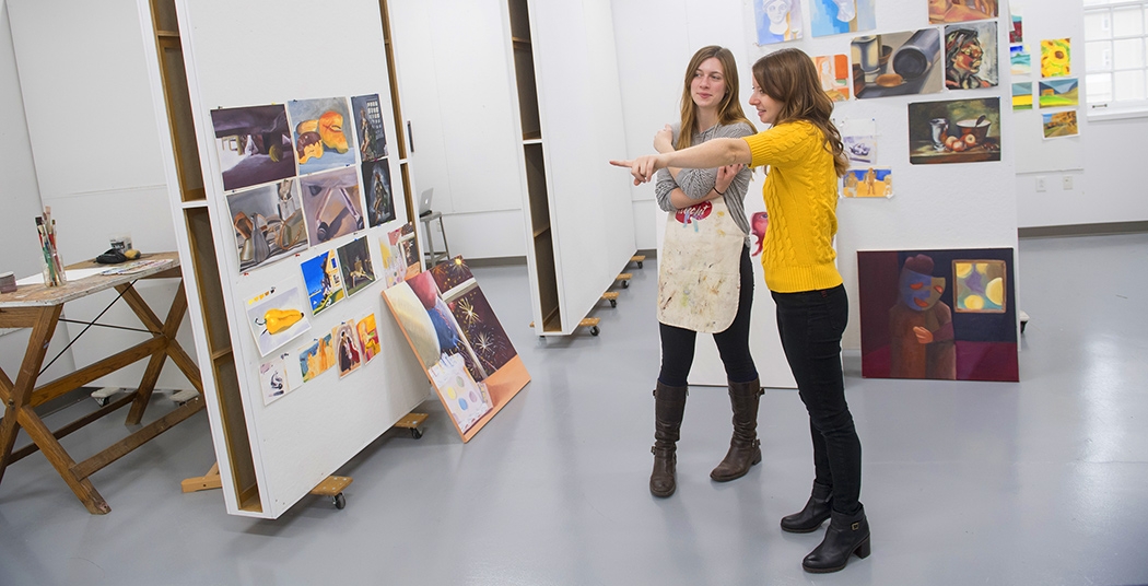 Professor Laini Nemett with student in a  painting studio.