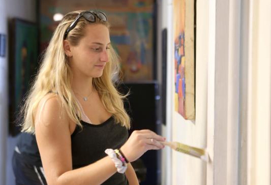 Rachel Meyers '19 helps paint at the Hamilton Hill Arts Center in 2015.