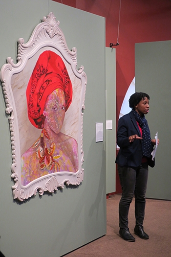 Adenike Hickson '22 with a painting by Firelei Báez