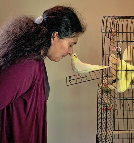 Rebecca (Becky) Cortez, professor of mechanical engineering and director of Engineering at Union, whistles with Maddie, her daughter's cockatiel.