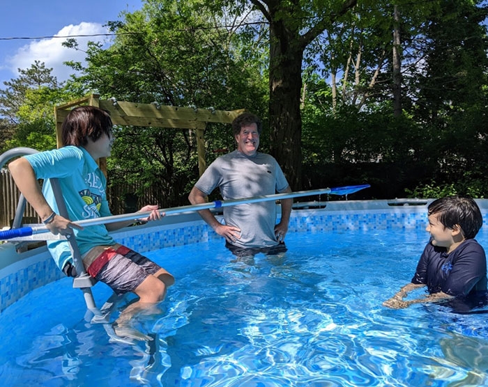 Chad Orzel in the pool with his children