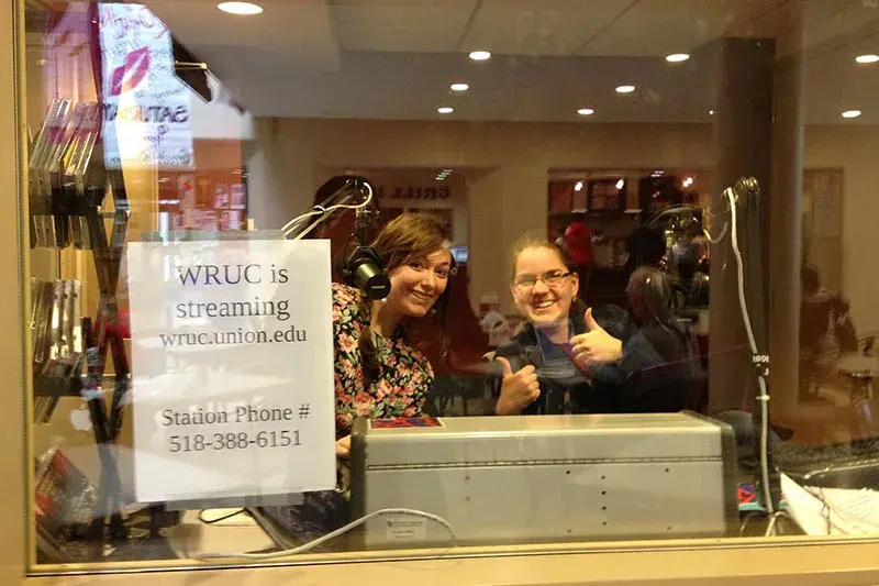 Greta Bieg ’15, left, and Emily Crampe ’15 in WRUC’s “fishbowl studio” on the first floor of Reamer Campus Center in 2013.
