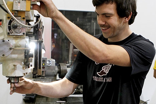 Kyle Bucklin ’12, an engineer at Ecovative, helps design custom machine pieces for the company’s manufacturing process.