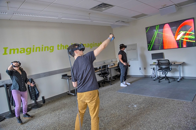 Sonia Sandoval '16, Zachary Cormier '22 and Maxx Jakeway '21 explore Union's new Imagine Lab in Wold 118.