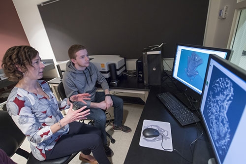 Prof. Jennifer Currey with a student