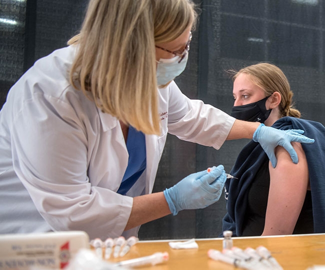 Darby Leid ’22 gets a vaccine shot from Joan Thompson, a registered nurse