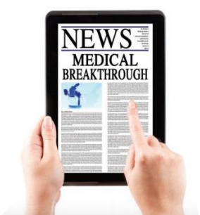 Hands surfing medical news on a tablet