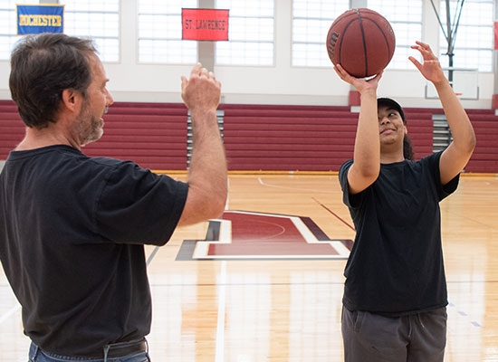 Jonathan Marr, senior lecturer in physics and astronomy, works with Genesis Santana ’21 on her shooting technique. For her summer research project, Santana is learning how the principles of physics apply to the science of basketball.