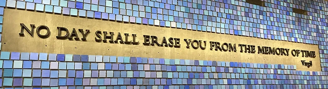 The Virgil quote, "No day shall erase you from the memory of time," adorns a wall at the 9/11 Memorial and Museum.