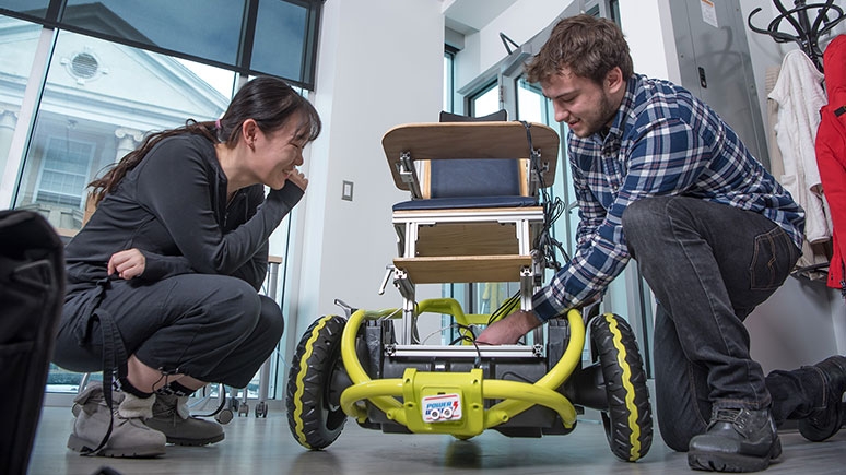 Engineering students Yueyin Su and Benjamin Davis collaborate on the replicable power wheel chair.