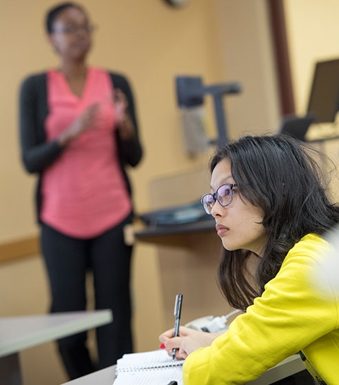 Professor Raeburn teaches a course in economics