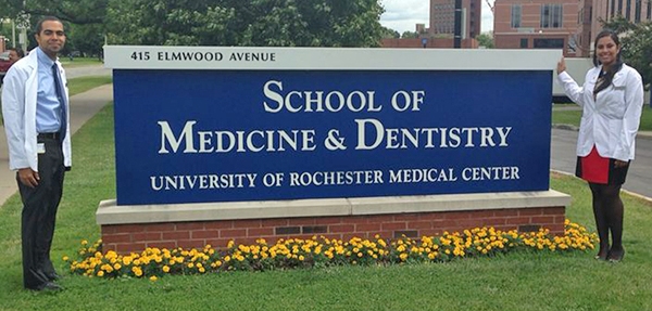 Kenia Valdez '12 and Derrik German '12 in front of a denistry school sign