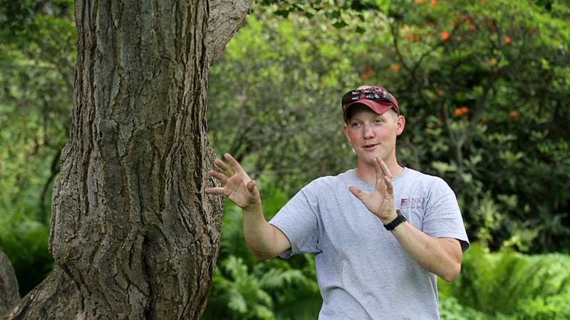 College arborist Joe Conti talks about a ginkgo tree in Jackson's Garden.