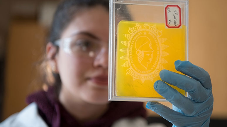 Zineb Hajjaj '20 inspects aerogel that has been dyed for window applications. 