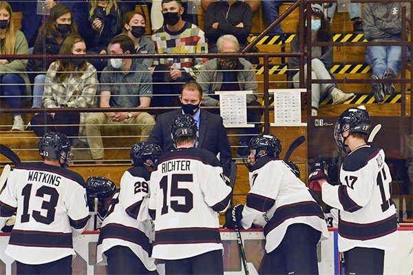 Men's hockey coach Rick Bennett talks with his players during a recent game.