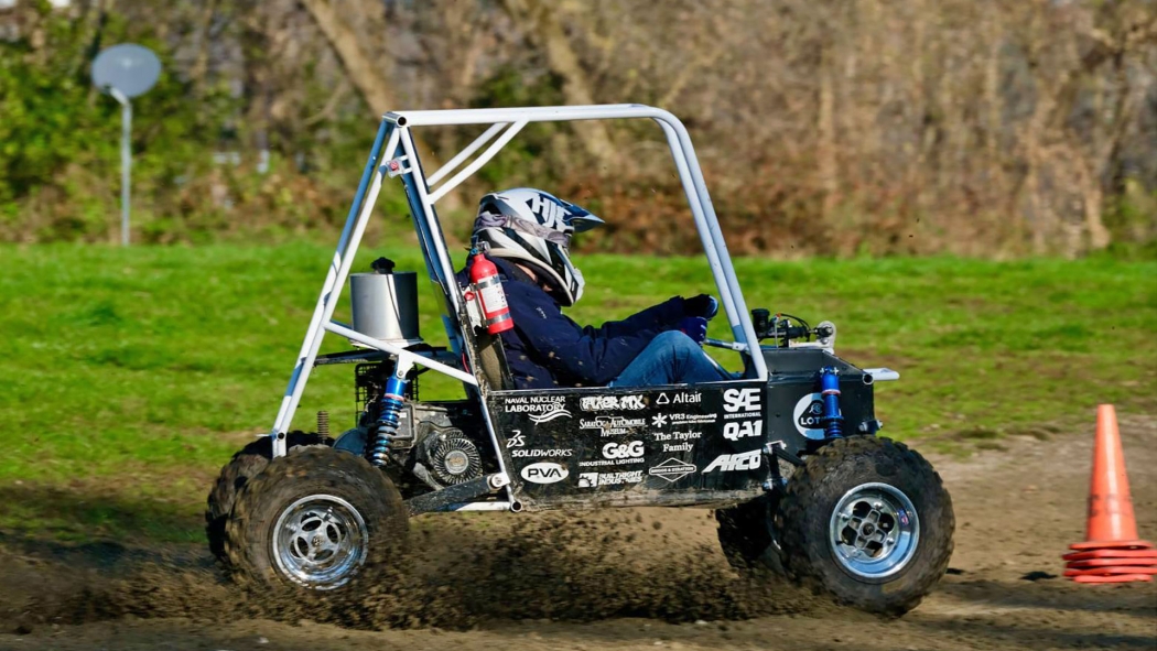 A student test drives one of the baja race vehicles.